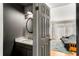 Updated half-bathroom with dark vanity and round mirror at 5696 Kingsport Dr # 3, Atlanta, GA 30342