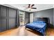Spacious bedroom with wood floors, large window and ceiling fan at 5696 Kingsport Dr # 3, Atlanta, GA 30342