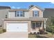 Two-story house with gray siding and a white garage door at 10922 Wheeler Trce, Hampton, GA 30228