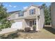 Two-story house with gray siding and a white garage door at 10922 Wheeler Trce, Hampton, GA 30228