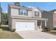 Two-story house with gray siding and a white garage door at 10922 Wheeler Trce, Hampton, GA 30228