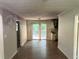 Living room with wood-look floors and access to deck and kitchen at 57 Hillcrest Dr, Austell, GA 30168