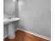 Small bathroom with pedestal sink and wood-look floor at 1861 Old Dogwood, Jonesboro, GA 30238
