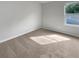 Bright bedroom featuring neutral carpet and a window at 1861 Old Dogwood, Jonesboro, GA 30238