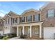 Brick front townhouse with two-car garage and porch at 1861 Old Dogwood, Jonesboro, GA 30238