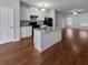 Modern kitchen with island, hardwood floors, and stainless steel appliances at 1861 Old Dogwood, Jonesboro, GA 30238