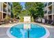 Community pool with surrounding lounge chairs at 2240 Cheshire Bridge Rd # 205, Atlanta, GA 30324