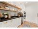 Butler's pantry with open shelving, dark countertops, and a farmhouse sink at 4391 Blackland Ne Dr, Marietta, GA 30067