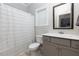 Bathroom with gray vanity, shower/tub combo, and neutral decor at 133 Gingers Way, Mcdonough, GA 30252