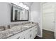 Bathroom with granite countertop, white cabinets, and a walk-in closet at 1372 Downington Nw Ln, Acworth, GA 30101