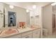 Retro bathroom with double pink sinks and a large mirror at 3368 Regalwoods Dr, Atlanta, GA 30340