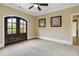 Spacious bedroom with French doors and ceiling fan at 480 Lancashire Dr, Marietta, GA 30068