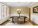 Formal dining room with hardwood floors, chandelier, and large windows at 480 Lancashire Dr, Marietta, GA 30068