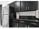 Modern kitchen with black cabinets and gold handles at 3648 Peachtree Ne Rd # 1A, Atlanta, GA 30319