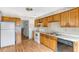 Kitchen boasts wood cabinets, appliances, and hardwood floors at 3664 Broadview Ct, Decatur, GA 30032