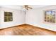 Hardwood floor bedroom with a ceiling fan and large window at 3664 Broadview Ct, Decatur, GA 30032