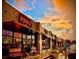 Evening view of shops and restaurants under a dramatic sunset at 4085 Longleaf Ln, Tucker, GA 30084