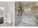 Large walk-in shower with gray tile and glass enclosure at 4085 Longleaf Ln, Tucker, GA 30084
