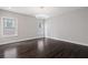 Bright bedroom with dark hardwood floors and two windows at 4085 Longleaf Ln, Tucker, GA 30084