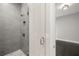 Bathroom with gray tile shower, glass enclosure, and modern fixtures at 4085 Longleaf Ln, Tucker, GA 30084