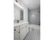 Bathroom with gray tile, star patterned floor and white vanity at 4085 Longleaf Ln, Tucker, GA 30084