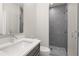 Bathroom with a gray tile shower, white vanity, and toilet at 4085 Longleaf Ln, Tucker, GA 30084