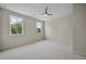 Bedroom with gray carpet, ceiling fan, and two windows at 4085 Longleaf Ln, Tucker, GA 30084