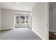 Bright bedroom with gray carpeting and a large window offering a view at 4085 Longleaf Ln, Tucker, GA 30084