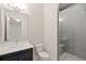 Bathroom with gray tile shower, white vanity, and a toilet at 4085 Longleaf Ln, Tucker, GA 30084