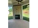 Covered patio features an outdoor fireplace and ceiling fan at 3036 Zodiac Ct, Lawrenceville, GA 30044