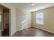 Bright bedroom with wood-look flooring, neutral walls, and access to another room at 317 Shasta Ln, Mcdonough, GA 30253