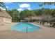 Community swimming pool with lounge chairs and tables at 523 Black Horse Cir, Canton, GA 30114