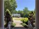 View from porch with lion statues and a tree-lined driveway at 595 Huiet Dr, Mcdonough, GA 30252