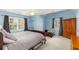 Spacious bedroom with light blue walls, a large bed, and plenty of natural light at 1028 Longwood Dr, Woodstock, GA 30189