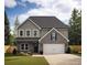 Two story house with gray siding and a brick front at 3301 Pepperpike Ct, Loganville, GA 30052