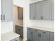 Gray cabinets, white quartz countertops, and ample storage space at 3301 Pepperpike Ct, Loganville, GA 30052
