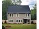 Two-story house with gray siding, dark roof, and landscaped lawn at 3301 Pepperpike Ct, Loganville, GA 30052