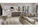 Open floor plan boasts a spacious kitchen with island and adjacent living room at 3301 Pepperpike Ct, Loganville, GA 30052