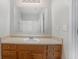 Bathroom vanity with wood cabinets and a large mirror at 705 Chase Ln, Mcdonough, GA 30253