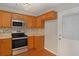 Modern kitchen with wood cabinets and stainless steel appliances at 705 Chase Ln, Mcdonough, GA 30253