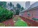 Brick home with fenced backyard and landscaping at 7270 Valley Forest Dr, Cumming, GA 30041