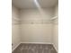 Large walk-in closet with wire shelving and neutral carpeting at 950 Sunny Lake Dr, Lawrenceville, GA 30043