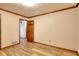 Simple bedroom with light walls, wood flooring, and an interior door at 452 Hightower Ridge Rd, Covington, GA 30014