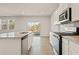 Modern kitchen with white cabinets, granite countertops, and stainless steel appliances at 8641 Paradise Dr, Douglasville, GA 30134