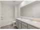 Bathroom with double vanity, tub, and gray cabinets at 2415 Autumn Wind Drive - Lot 33, Dacula, GA 30019