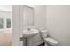 Small powder room with pedestal sink and toilet at 2415 Autumn Wind Drive - Lot 33, Dacula, GA 30019