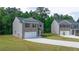 Two-story home with gray siding and a two-car garage at 2415 Autumn Wind Drive - Lot 33, Dacula, GA 30019