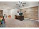 Home office in the basement with a desk, computer, and wood accent wall at 2318 Starr Lake Nw Dr, Acworth, GA 30101