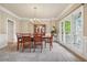 Formal dining room with chandelier, wooden table, and large windows at 2318 Starr Lake Nw Dr, Acworth, GA 30101