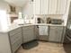 Kitchen with gray cabinets, quartz countertops, and stainless steel appliances at 500 Chestnut Walk, Canton, GA 30114